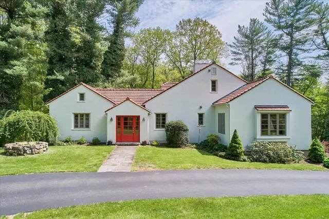 a front view of house with yard and green space