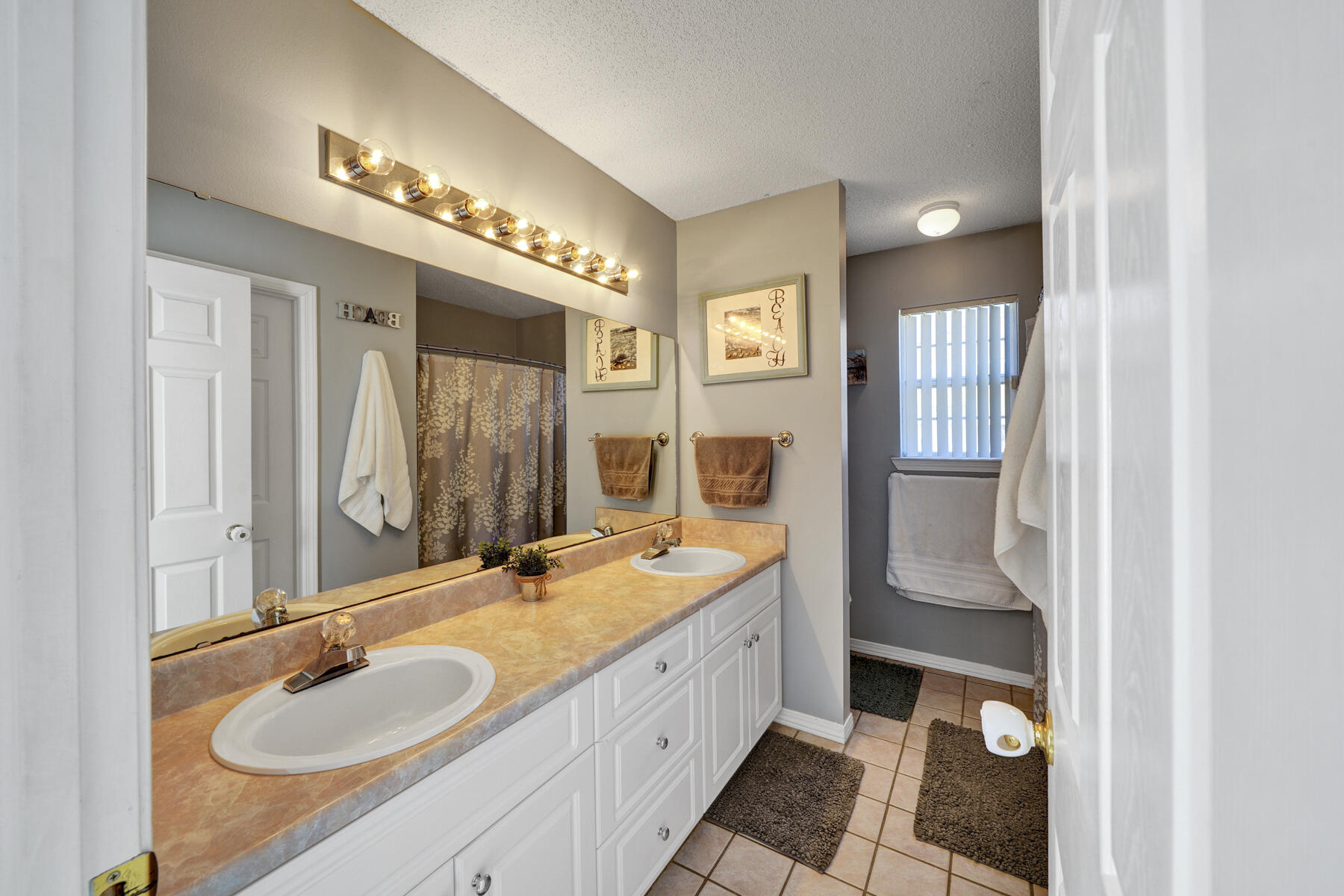 1787 Old Ranch Road Fort Walton Beach, FL 32547 - Photo 12 of 25 a spacious bathroom with a double vanity sink and a mirror