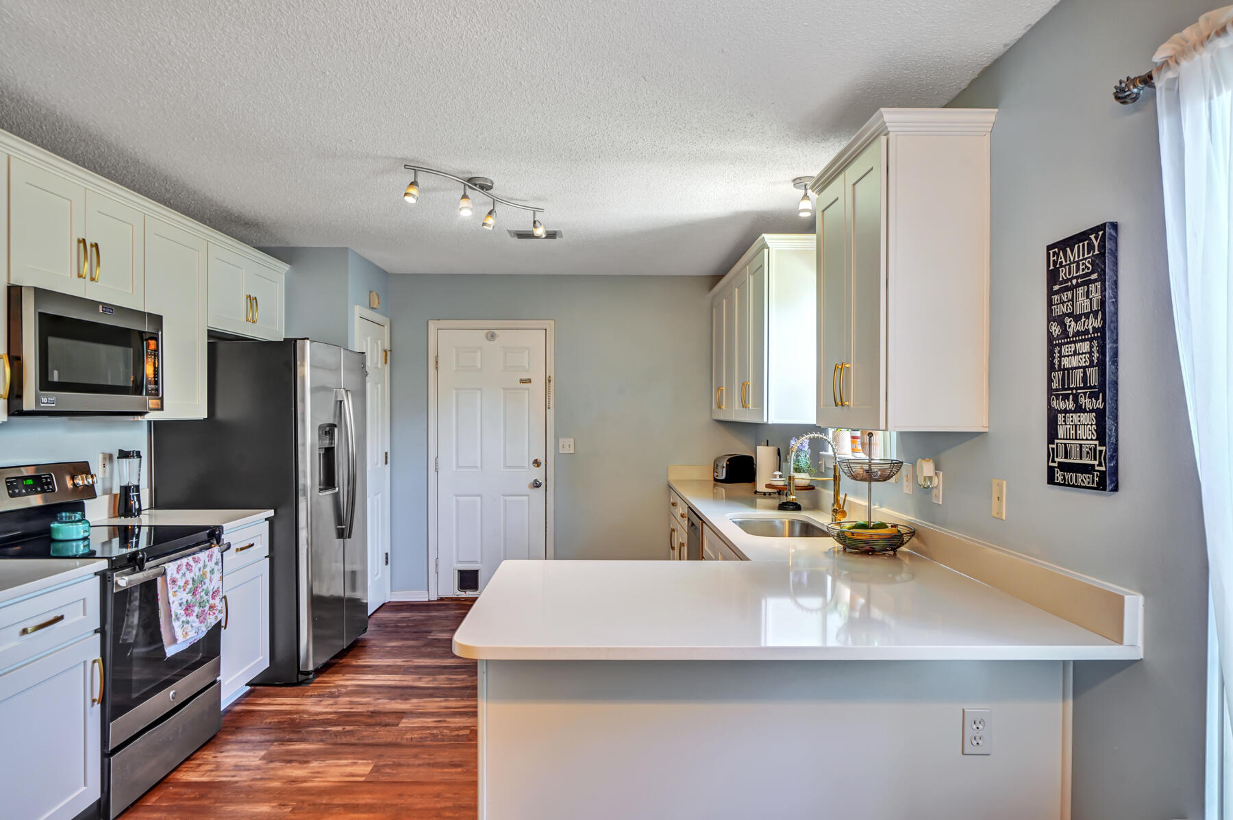 1787 Old Ranch Road Fort Walton Beach, FL 32547 - Photo 6 of 25 a kitchen with stainless steel appliances a sink stove and refrigerator