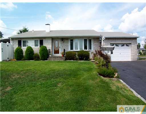 2 Rugby Road Colonia, NJ 07067 - Photo 1 of 15 a front view of a house with a yard and garage