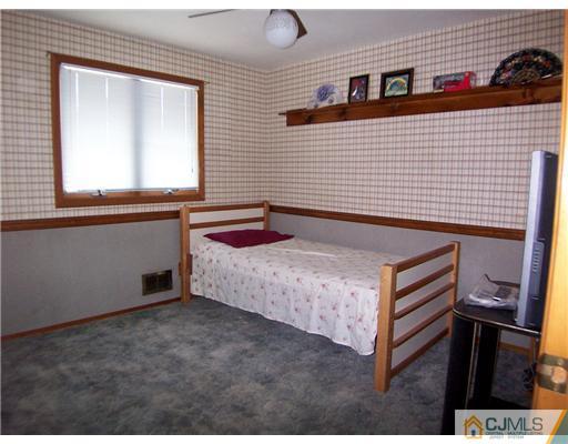 2 Rugby Road Colonia, NJ 07067 - Photo 8 of 15 a spacious bedroom with a bed and a window