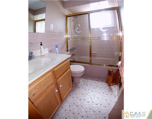 2 Rugby Road Colonia, NJ 07067 - Photo 10 of 15 a bathroom with a sink a toilet and shower