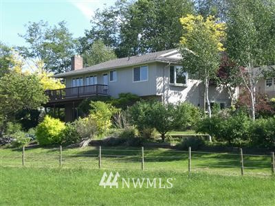 2977 Fox Road Ferndale, WA 98248 - Photo 1 of 1 a backyard of a house with plants and large trees
