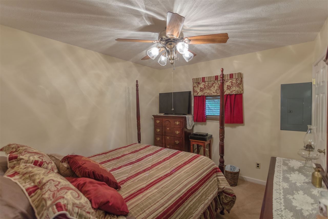 604 North Fork Road Amherst, VA 24521 - Photo 3 of 50 a bedroom with a bed and a flat screen tv