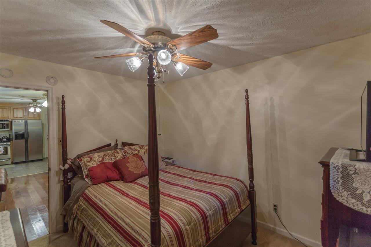 604 North Fork Road Amherst, VA 24521 - Photo 4 of 50 a bedroom with a bed and a chandelier