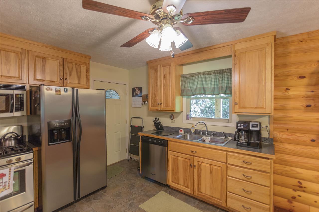 604 North Fork Road Amherst, VA 24521 - Photo 8 of 50 a kitchen with stainless steel appliances granite countertop a refrigerator a sink a stove and white cabinets