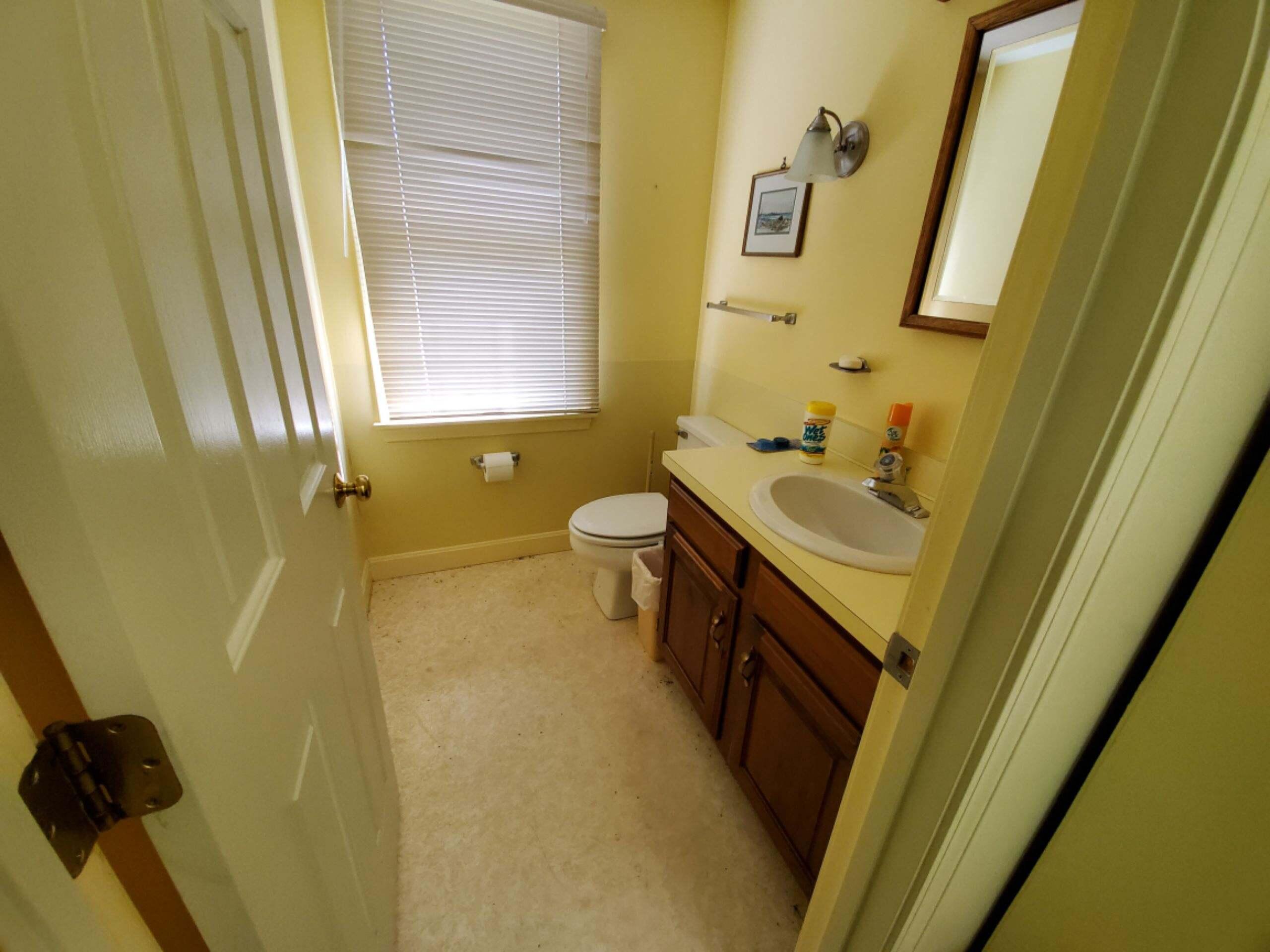 250-252 Underpass Road Brewster, MA 02631 - Photo 27 of 30 a bathroom with a sink a toilet and a mirror