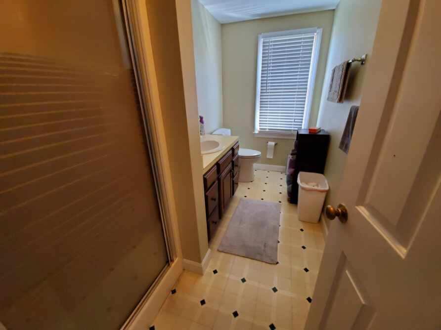 250-252 Underpass Road Brewster, MA 02631 - Photo 28 of 30 a bathroom with a sink a toilet a mirror and a window