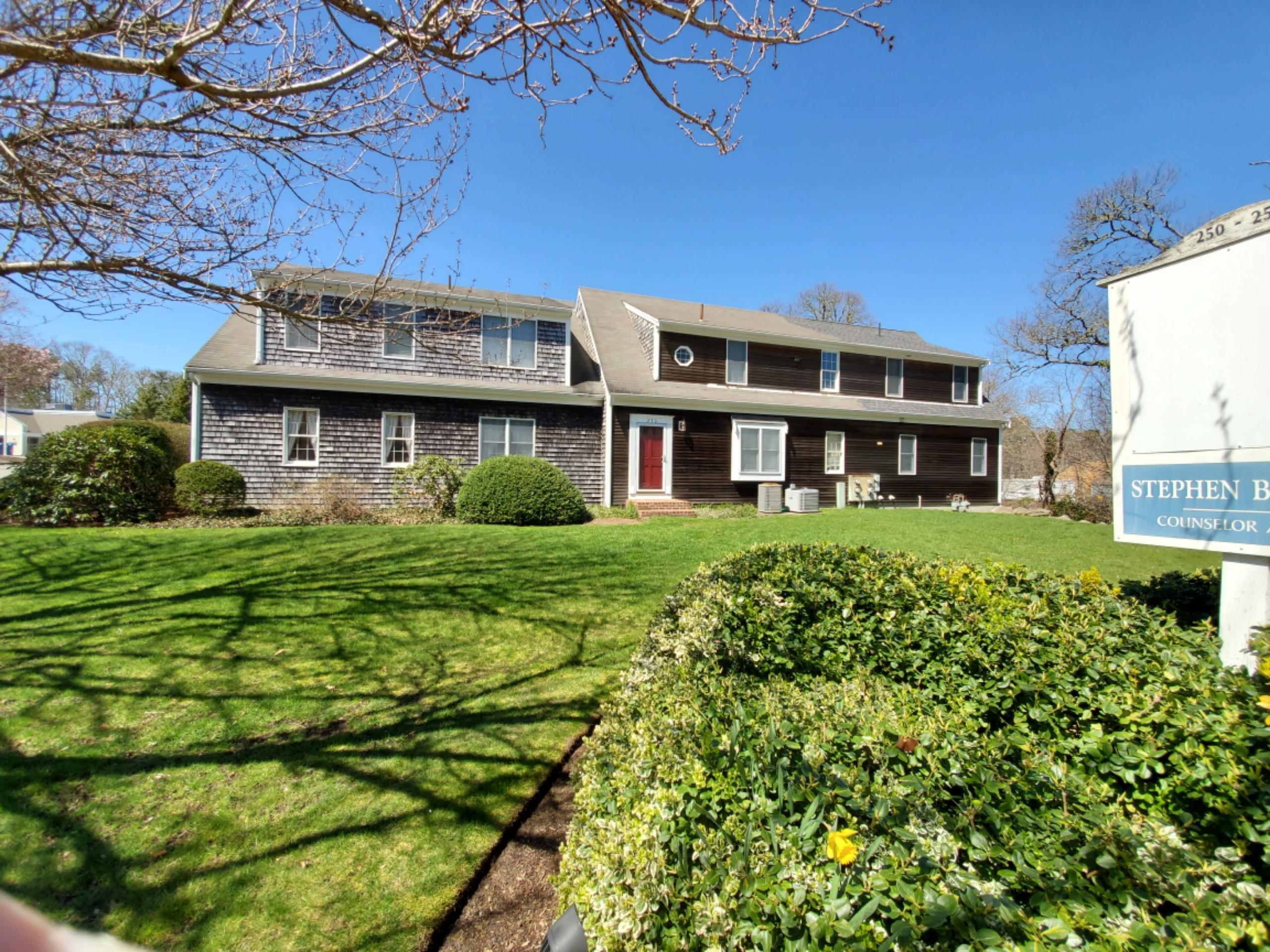 250-252 Underpass Road Brewster, MA 02631 - Photo 3 of 30 a front view of a residential apartment building with a yard