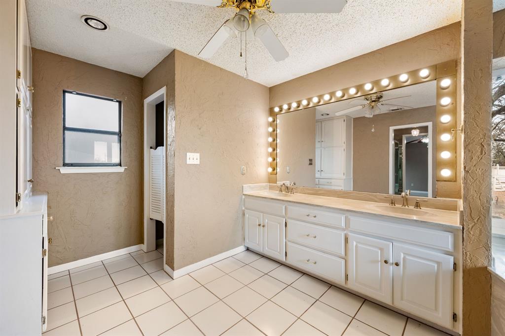 7260 Hudson Cemetery Road Mansfield, TX 76063 - Photo 24 of 40 Bathroom vanity featuring dual sinks, a large illuminated mirror, and white cabinetry