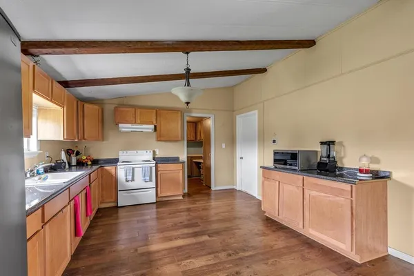 a kitchen with stainless steel appliances a sink and stove top oven