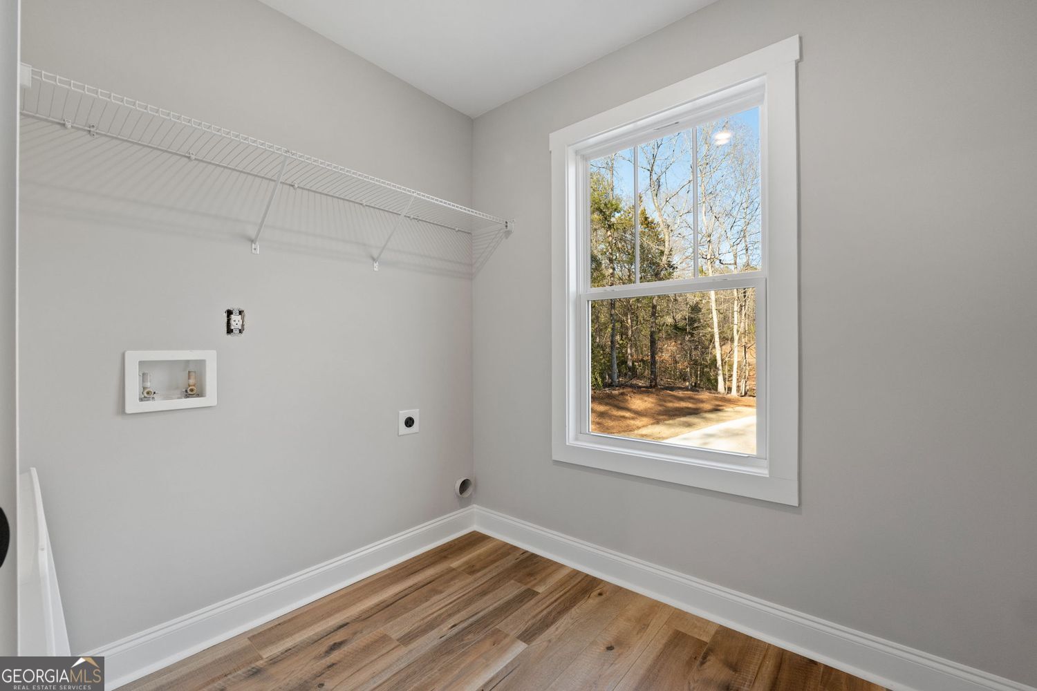 1578 English Road Forsyth, GA 31029 - Photo 30 of 40 a view of an empty room with wooden floor and a window