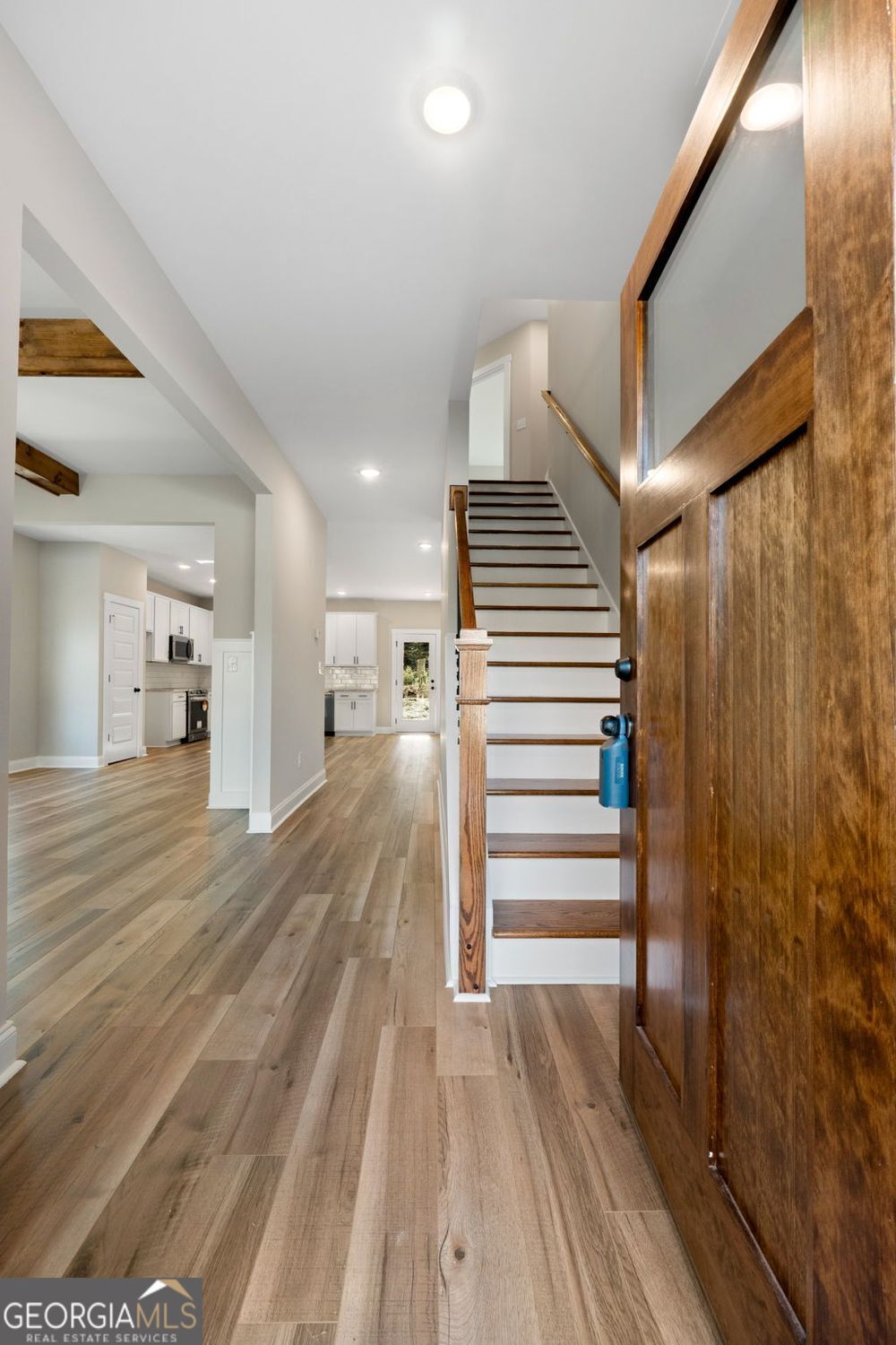 1578 English Road Forsyth, GA 31029 - Photo 8 of 40 a view of a hallway with wooden floor and staircase