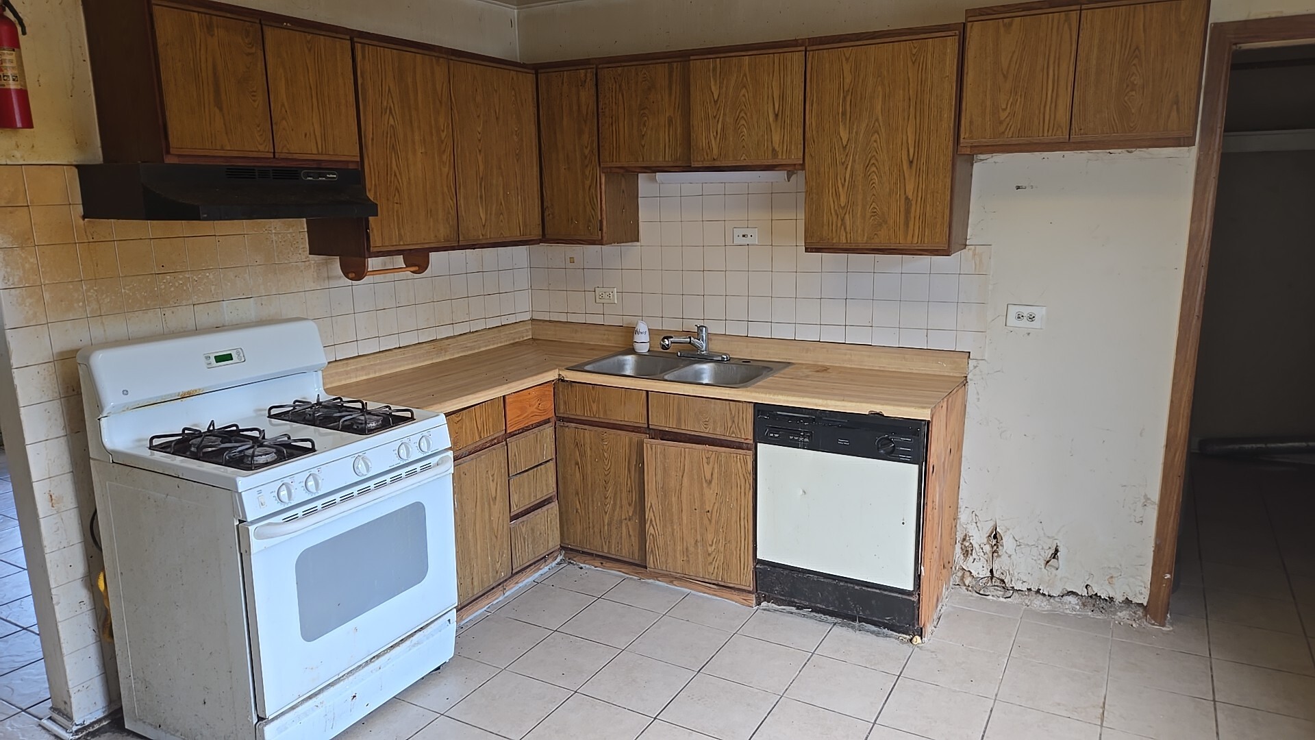 4627 Saratoga Road Richton Park, IL 60471 - Photo 11 of 12 a kitchen with a stove sink and cabinets
