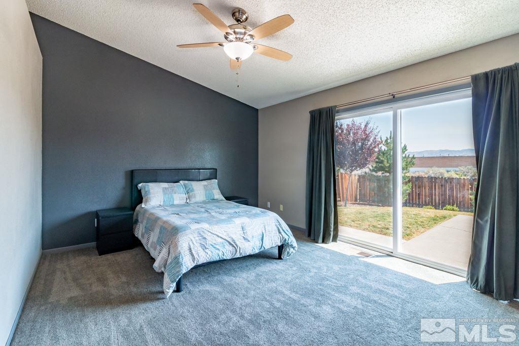 7540 Devonshire Lane Reno, NV 89511 - Photo 12 of 25 a spacious bedroom with a bed and a large window
