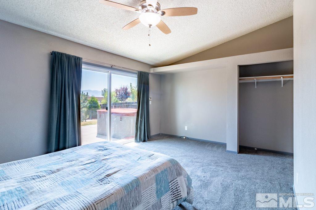 7540 Devonshire Lane Reno, NV 89511 - Photo 14 of 25 a bedroom with a bed and a chandelier