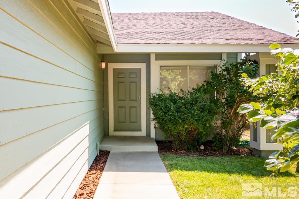 7540 Devonshire Lane Reno, NV 89511 - Photo 2 of 25 a front view of a house with a yard