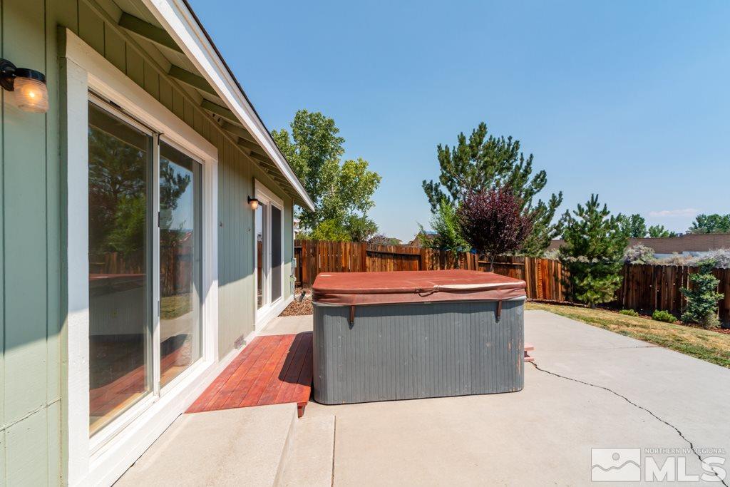 7540 Devonshire Lane Reno, NV 89511 - Photo 24 of 25 a view of a backyard with couches under an umbrella
