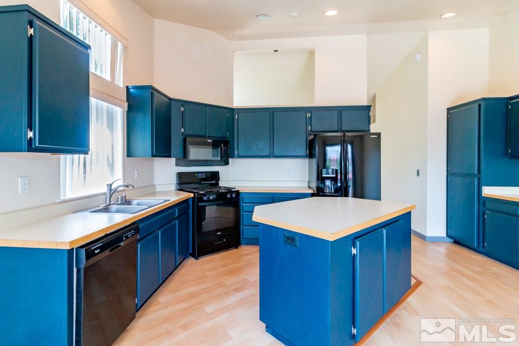 7540 Devonshire Lane Reno, NV 89511 - Photo 7 of 25 a kitchen with stainless steel appliances granite countertop a sink stove and refrigerator