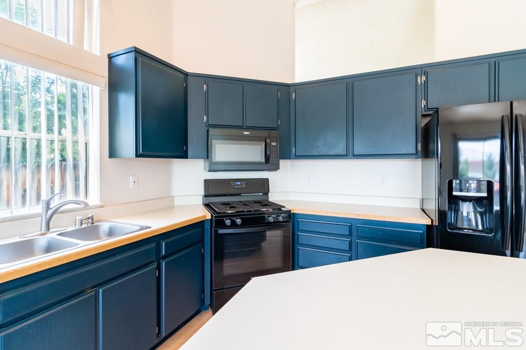 7540 Devonshire Lane Reno, NV 89511 - Photo 8 of 25 a kitchen with a sink a stove and refrigerator