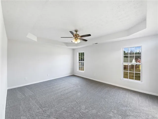 a view of a livingroom with a ceiling fan and window