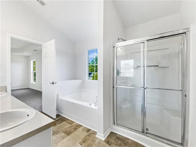 a bathroom with a bathtub and a shower