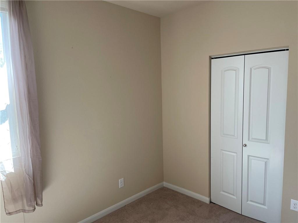 1420 Nevarez Kyle, TX 78640 - Photo 9 of 9 Carpeted flooring and a convenient closet define this versatile room.