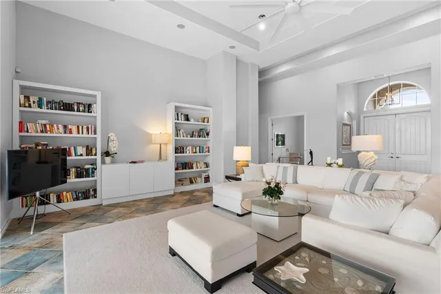a living room with furniture and a chandelier