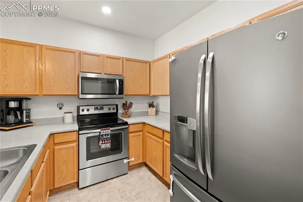 a kitchen with a refrigerator stove and microwave