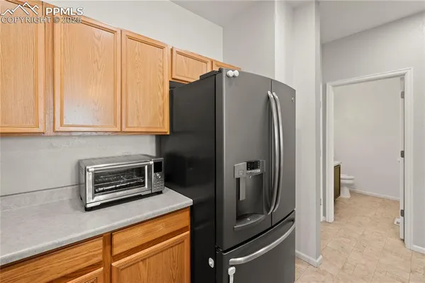 a kitchen with stainless steel appliances granite countertop a refrigerator and a stove top oven