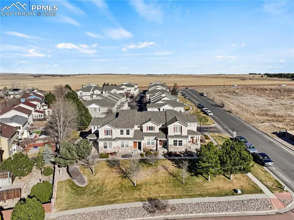 an aerial view of residential building with outdoor space and ocean