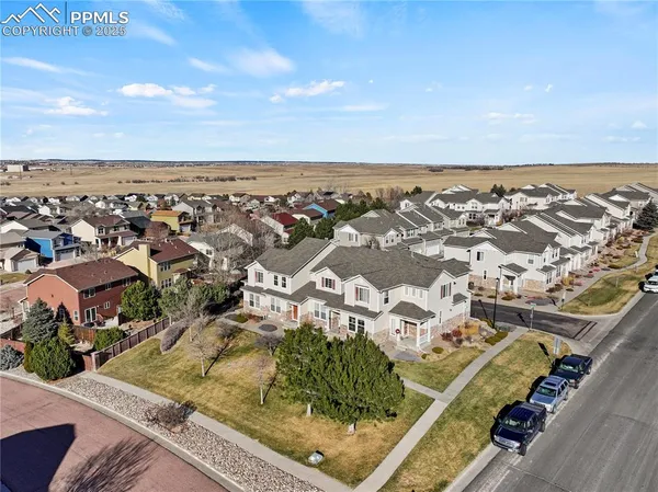 an aerial view of residential houses with outdoor space
