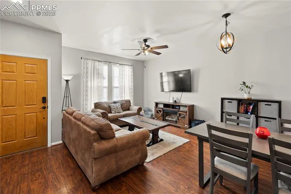 a living room with fireplace furniture and a flat screen tv