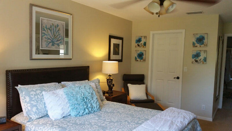 174 Southwest Sea Lion Road Port St. Lucie, FL 34953 - Photo 12 of 31 a bedroom with a bed and a painting on the wall