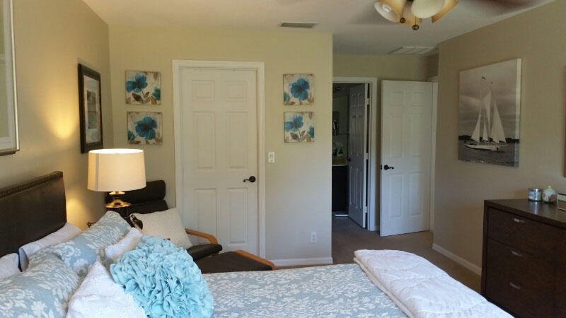174 Southwest Sea Lion Road Port St. Lucie, FL 34953 - Photo 13 of 31 a bedroom with a bed and wooden floor