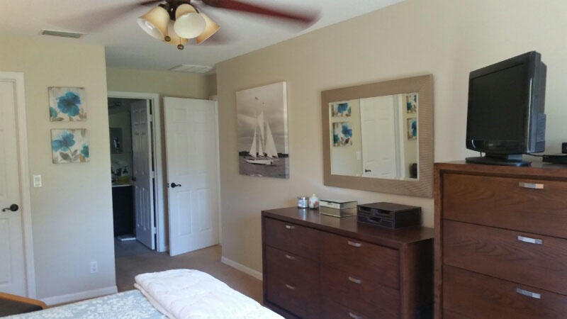 174 Southwest Sea Lion Road Port St. Lucie, FL 34953 - Photo 14 of 31 a bathroom with a sink a toilet and mirror