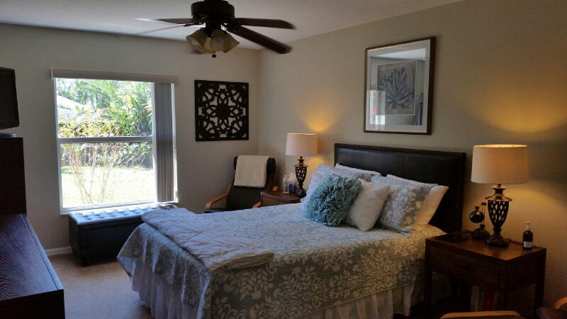 174 Southwest Sea Lion Road Port St. Lucie, FL 34953 - Photo 15 of 31 a bedroom with a bed and a window
