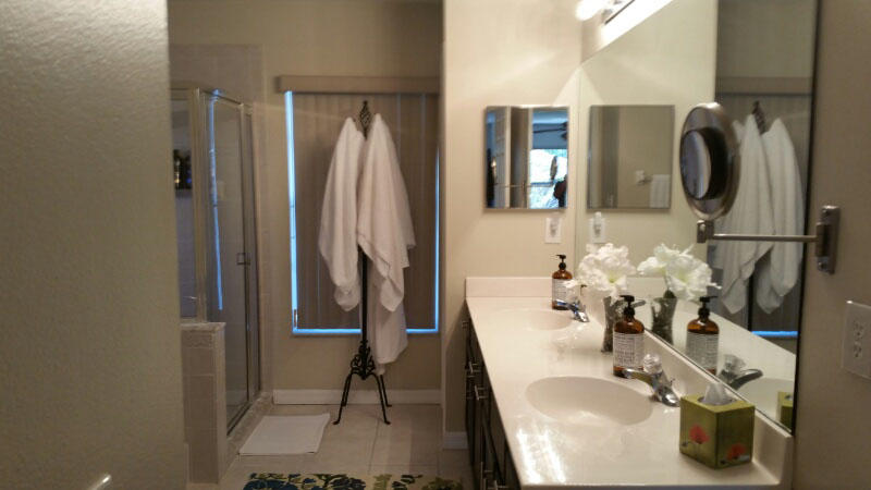 174 Southwest Sea Lion Road Port St. Lucie, FL 34953 - Photo 16 of 31 a bathroom with a sink vanity and mirror