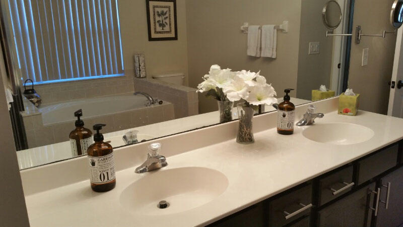 174 Southwest Sea Lion Road Port St. Lucie, FL 34953 - Photo 17 of 31 a bathroom with a sink and a mirror