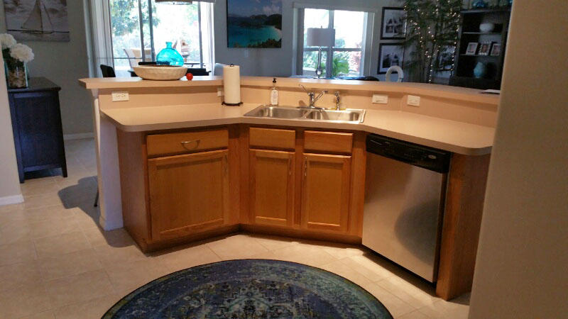 174 Southwest Sea Lion Road Port St. Lucie, FL 34953 - Photo 2 of 31 a kitchen with a sink and cabinets