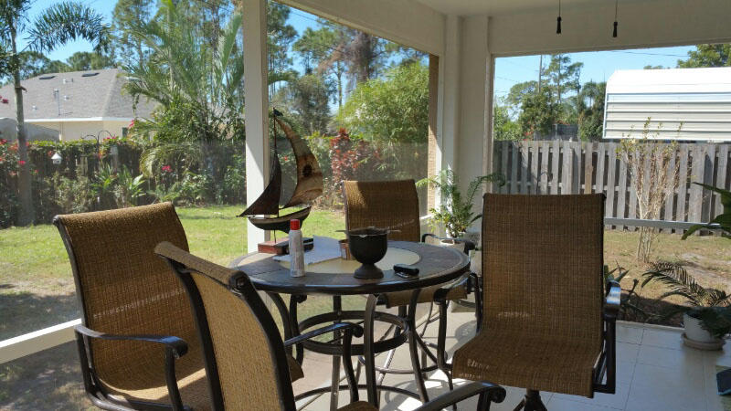 174 Southwest Sea Lion Road Port St. Lucie, FL 34953 - Photo 28 of 31 a view of a dining room with furniture and chandelier
