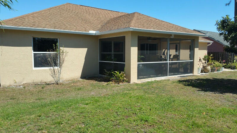 174 Southwest Sea Lion Road Port St. Lucie, FL 34953 - Photo 29 of 31 a front view of a house with a yard