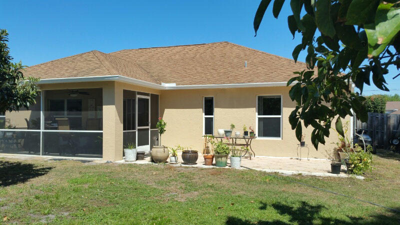 174 Southwest Sea Lion Road Port St. Lucie, FL 34953 - Photo 30 of 31 a view of a house with backyard and sitting area
