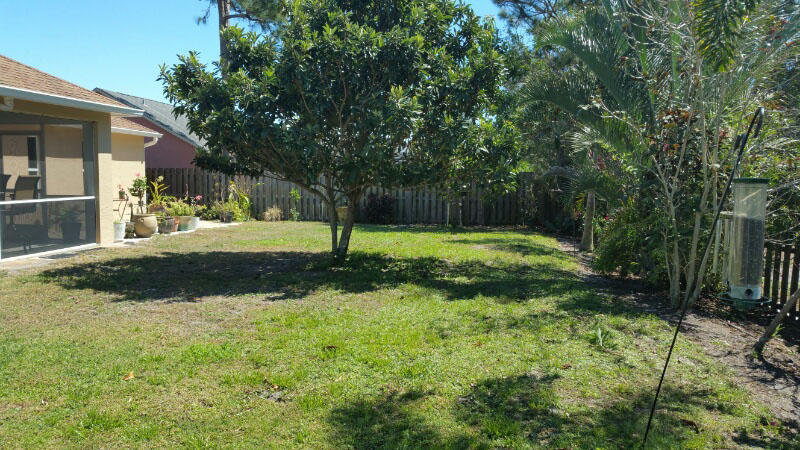 174 Southwest Sea Lion Road Port St. Lucie, FL 34953 - Photo 31 of 31 a view of a tree in a yard
