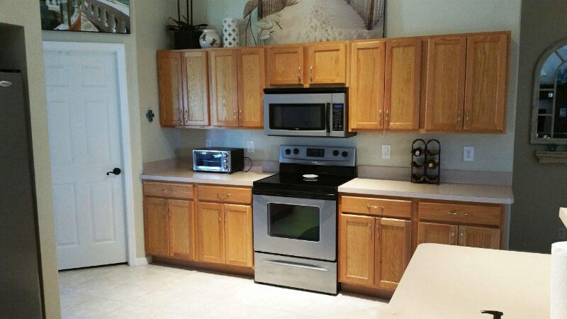 174 Southwest Sea Lion Road Port St. Lucie, FL 34953 - Photo 4 of 31 a kitchen with stainless steel appliances granite countertop a stove a sink and a refrigerator