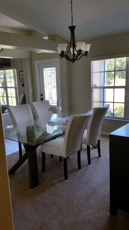 174 Southwest Sea Lion Road Port St. Lucie, FL 34953 - Photo 7 of 31 a view of a dining room with furniture window and outside view