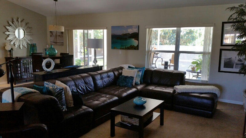 174 Southwest Sea Lion Road Port St. Lucie, FL 34953 - Photo 8 of 31 a living room with furniture and a large window