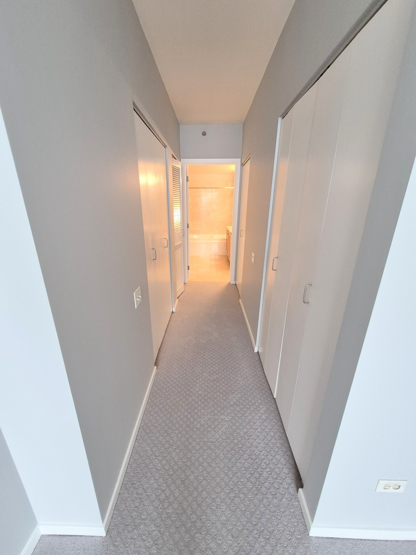 210 South Desplaines Street, Unit 707 Chicago, IL 60661 - Photo 13 of 21 a view of a hallway with a window