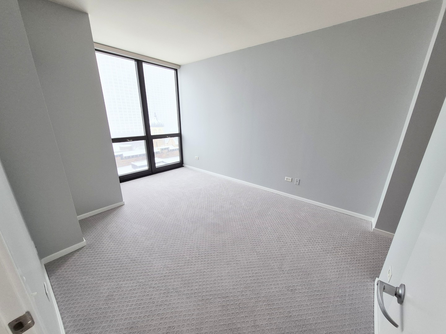 210 South Desplaines Street, Unit 707 Chicago, IL 60661 - Photo 14 of 21 an empty room with windows