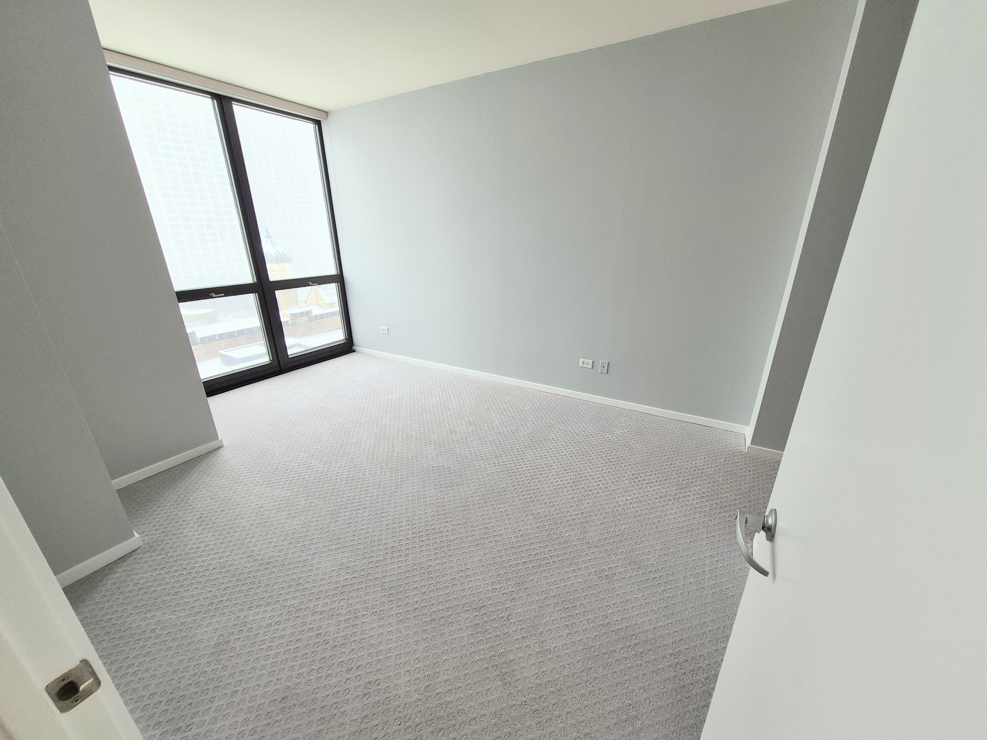 210 South Desplaines Street, Unit 707 Chicago, IL 60661 - Photo 16 of 21 wooden floor in an empty room with a window